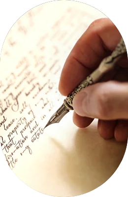a hand holding a vintage pen and writing something